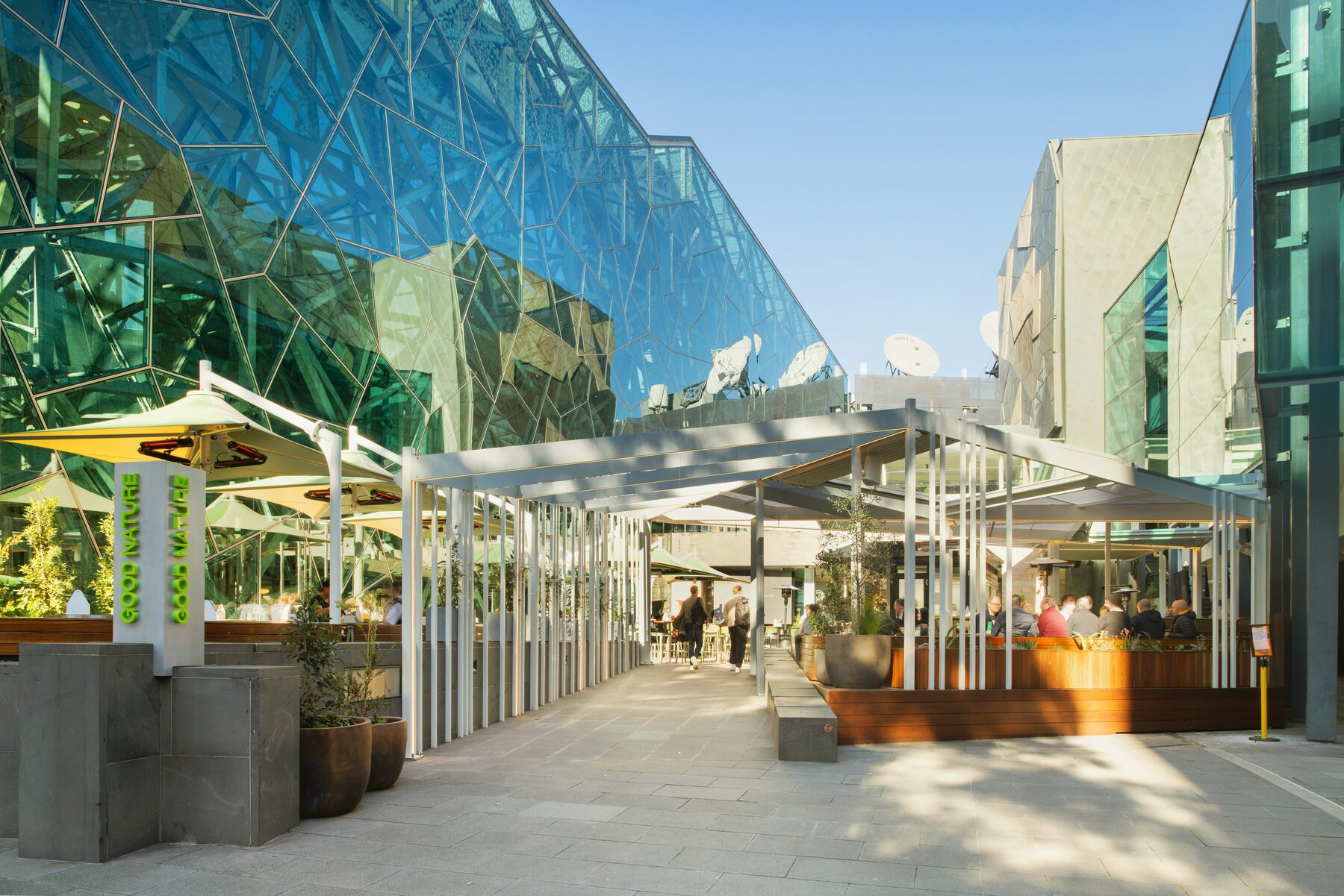 Outdoor dining area under the retractable roof at Good Nature Hotel