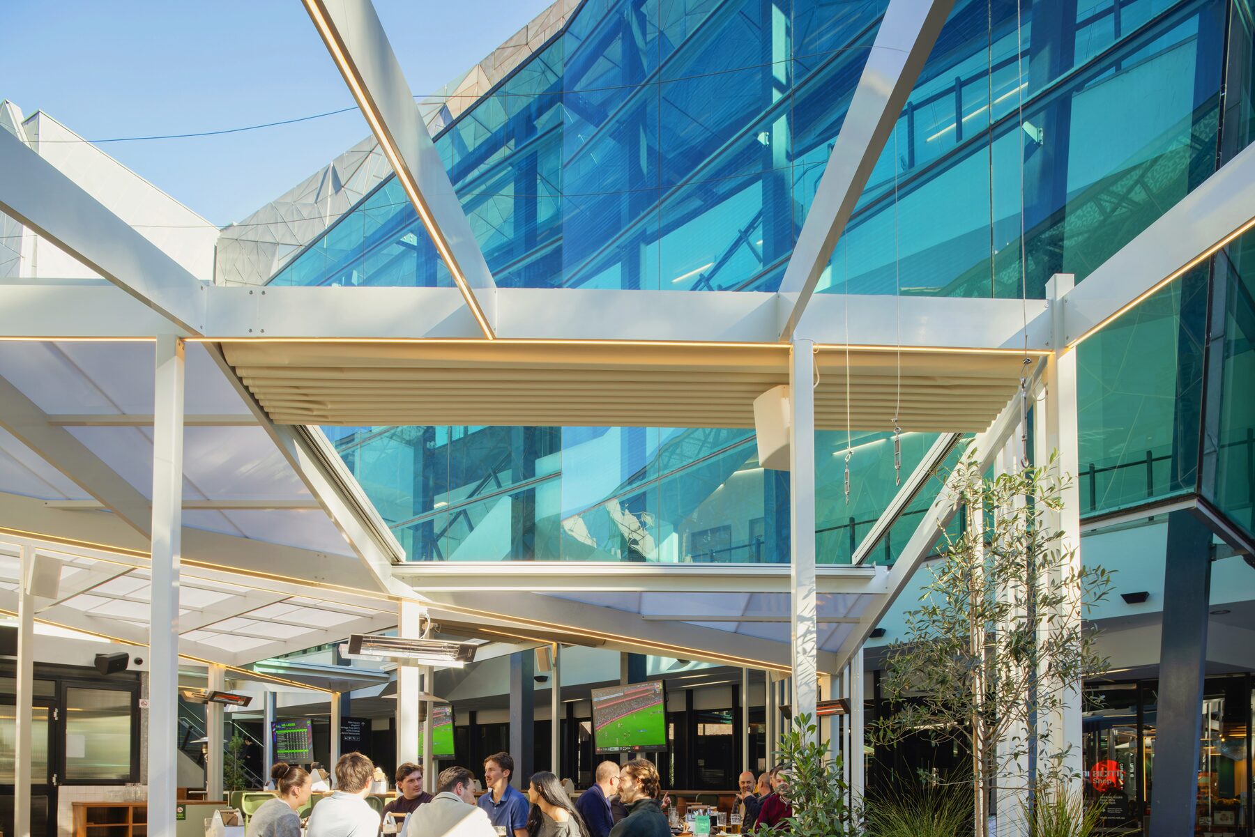 Retractable roof structure against the Federation Square glass facade