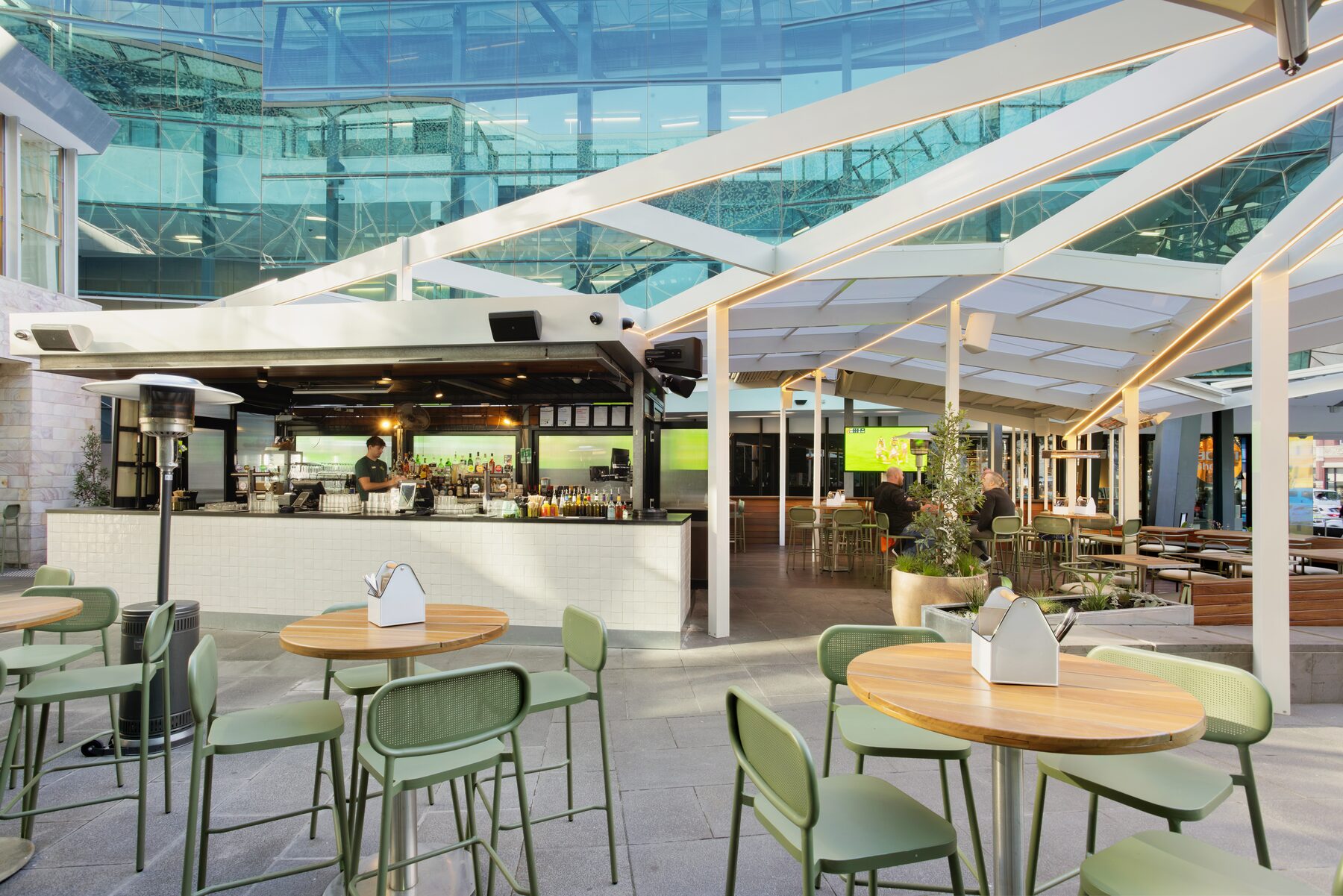 Bar and seating under the retractable roof at Good Nature Hotel Melbourne