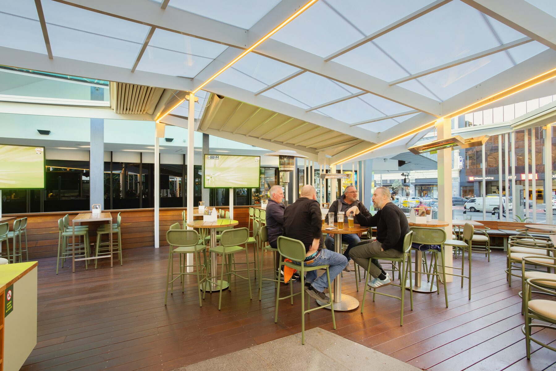 Guests dining in the all-weather outdoor area at Good Nature Hotel