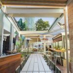 Thumbnail of Outdoor walkway and seating under the Good Nature Hotel roof structure