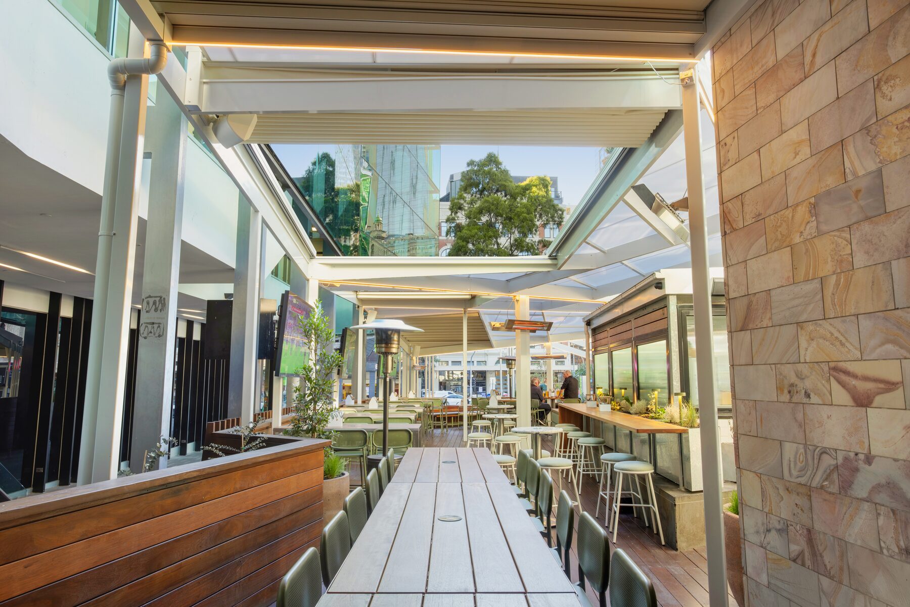 Outdoor walkway and seating under the Good Nature Hotel roof structure